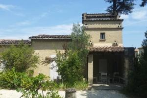 an external view of a building with a tower at Le Pigeonnier in Vaison-la-Romaine
