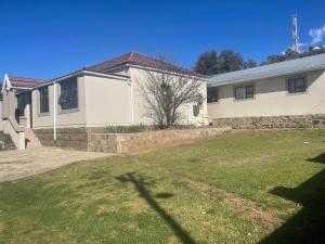a house with a yard in front of it at Mercy Land Guesthouse in Matatiele
