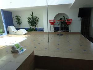 a room with a room with red chairs and a floor at GS Cuernavaca Drive Inn - Adults Only in Cuernavaca +22 photos