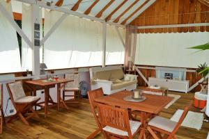 a living room with a table and chairs and a couch at Nathylodge in Bocas Town