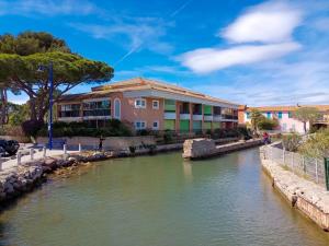 a river in front of a building at Parc des Salins in Hyères