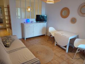 a living room with a couch and a table at Parc des Salins in Hyères