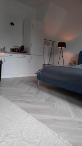 a living room with a bed and a kitchen at Suite city center in quiet street & airco in Antwerp
