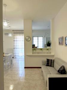 a living room with a couch and a table at Antares In Puglia in Monopoli