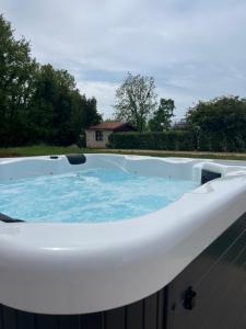 a large jacuzzi tub in a backyard at Modern Home Ula in Brtonigla