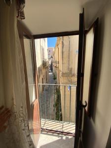 an open door to a balcony with a view at Civico 53 in Siracusa
