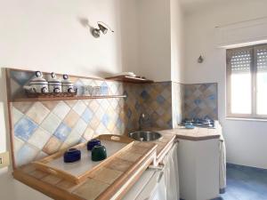 a kitchen with a sink and a counter top at Rosa Dei Venti Marettimo in Marettimo +56 photos