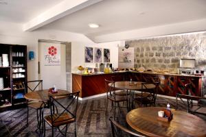 un restaurante con mesas y una barra con cocina en Pousada Flor de Penedo en Penedo