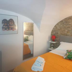 a bedroom with an orange bed and a mirror at Robert holiday apartment in Catania