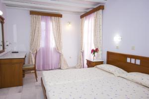Postel nebo postele na pokoji v ubytování Naxos Holidays