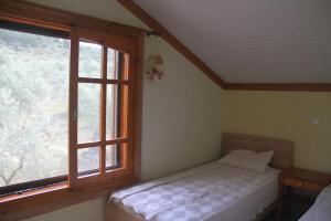 a bedroom with a bed and a large window at Villa Anta in Skala Kallirakhis