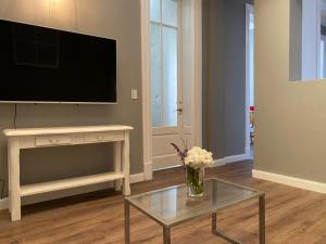 a living room with a television and a coffee table at Gorgeous apartment San Telmo up to 6 people in Buenos Aires