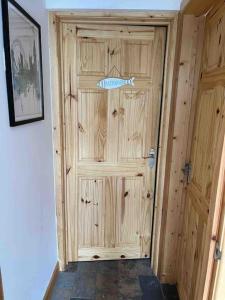 a wooden door with a fish on it in a room at The Dog House in Birkenhead