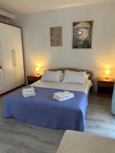 a bedroom with a bed with two towels on it at Villa Gloria in Dubrovnik