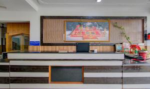 a large altar in a church with a picture on the wall at Itsy By Treebo - Satya Shree in Katra