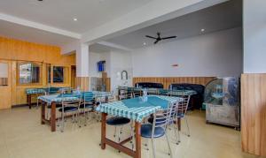 a dining room with blue tables and chairs at Itsy By Treebo - Satya Shree in Katra