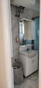 a bathroom with a sink and a mirror at Signature Idea hotel in Tirana