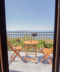 a table and chairs on a balcony with a view of the ocean at Stone house Marinko - Free Beach Parking in Tučepi