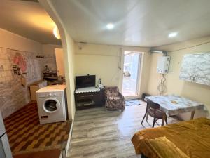 a room with a bed and a table with a washing machine at NunSon Guest House in Yerevan +15 photos