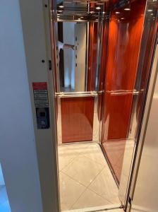 um chuveiro de metal com uma porta de vidro num quarto em Paralia Elena em Paralia Katerinis