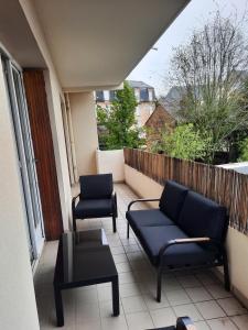 balkon z 2 krzesłami, kanapą i stołem w obiekcie Ruthen'Stay 1 bedroom Apartment w mieście Rodez