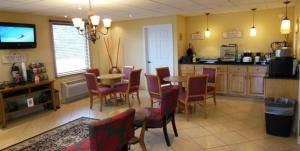 a kitchen and dining room with a table and chairs at Motel 6 Abbeville, AL in Abbeville