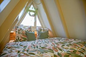 a bed with pillows in front of a window at Ferienhaus Nordic Harmony in Waldkirchen