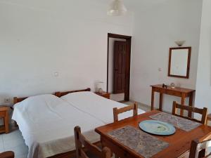 a bedroom with a bed and a table with a plate on it at Livadia Studios in Ropanianá