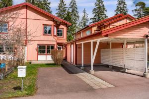 a house with a garage in front of it at Uppsala Large family home beside forest in Uppsala