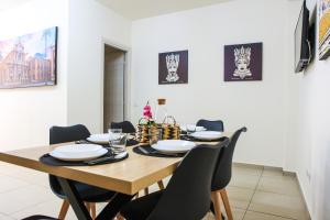 comedor con mesa de madera y sillas en Beatrix Home, en Catania
