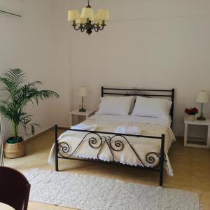 a bedroom with a bed with white pillows and a rug at Alexandra Villa in Bali