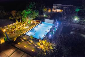 an overhead view of a swimming pool at night at Shisiram-Italian Luxury cottage Tabor Hills Resort in Vagamon