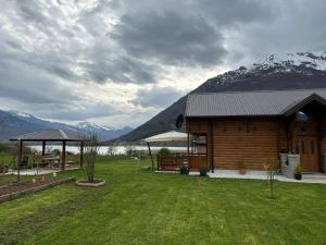 a log cabin with mountains in the background at The Lake Breeze Bay in Plav