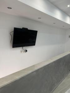 a flat screen tv hanging on a white wall at Apartman Katarina in Trebinje