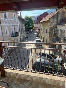a balcony with a view of a street with cars at Apartman Katarina in Trebinje