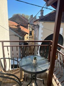 a table on a balcony with a view at Apartman Katarina in Trebinje