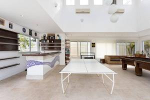 a living room with a ping pong table in it at Suites Guarujá Pernambuco in Guarujá