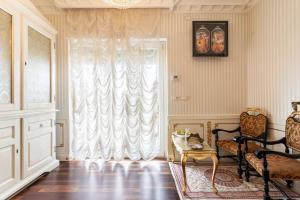 a living room with a large window and a chair at B&Boutique Lamezia Terme in Lamezia Terme