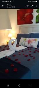 a bed with a swan made out of hearts at La Coloniale in Búzios