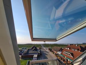 a view from a balcony of a town at Ferienwohnung Inselblick Norddeich mit Meerblick in Norden