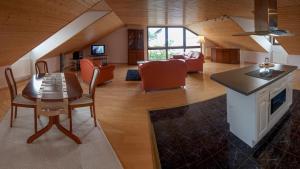 a kitchen and living room with a table and chairs at Hotel Am Lingelbach in Knüllwald