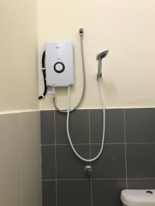a shower in a bathroom with a toilet at Myra Anne Home2Stay Alor Gajah Melaka in Kampong Dalong