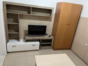 a room with a tv and a desk with a television at Urban Apartments in Ulcinj