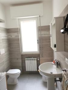 a bathroom with a white toilet and a sink at Ca' Beppino in Sestri Levante
