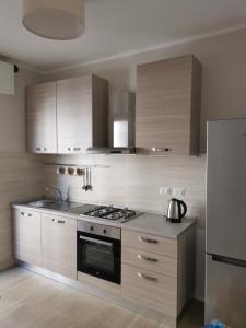 a kitchen with stainless steel appliances and wooden cabinets at Ca' Beppino in Sestri Levante