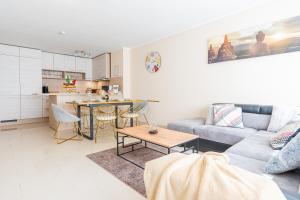 a living room with a couch and a table at Golden Design Zentral Office Kitchen Garage in Duisburg