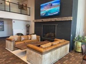 a living room with two couches and a fireplace at Bunk House in Madras