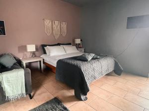 a bedroom with a bed and two tables with lamps at The Blue Door Apartment in Cahersiveen