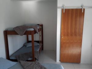 Postel nebo postele na pokoji v ubytování Recanto da Preguiça - Suites