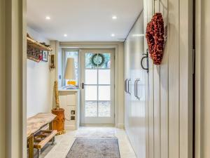 a hallway with a door leading into a room with a window at Pass the Keys Beautiful Cottage In South Downs in Chichester +62 photos